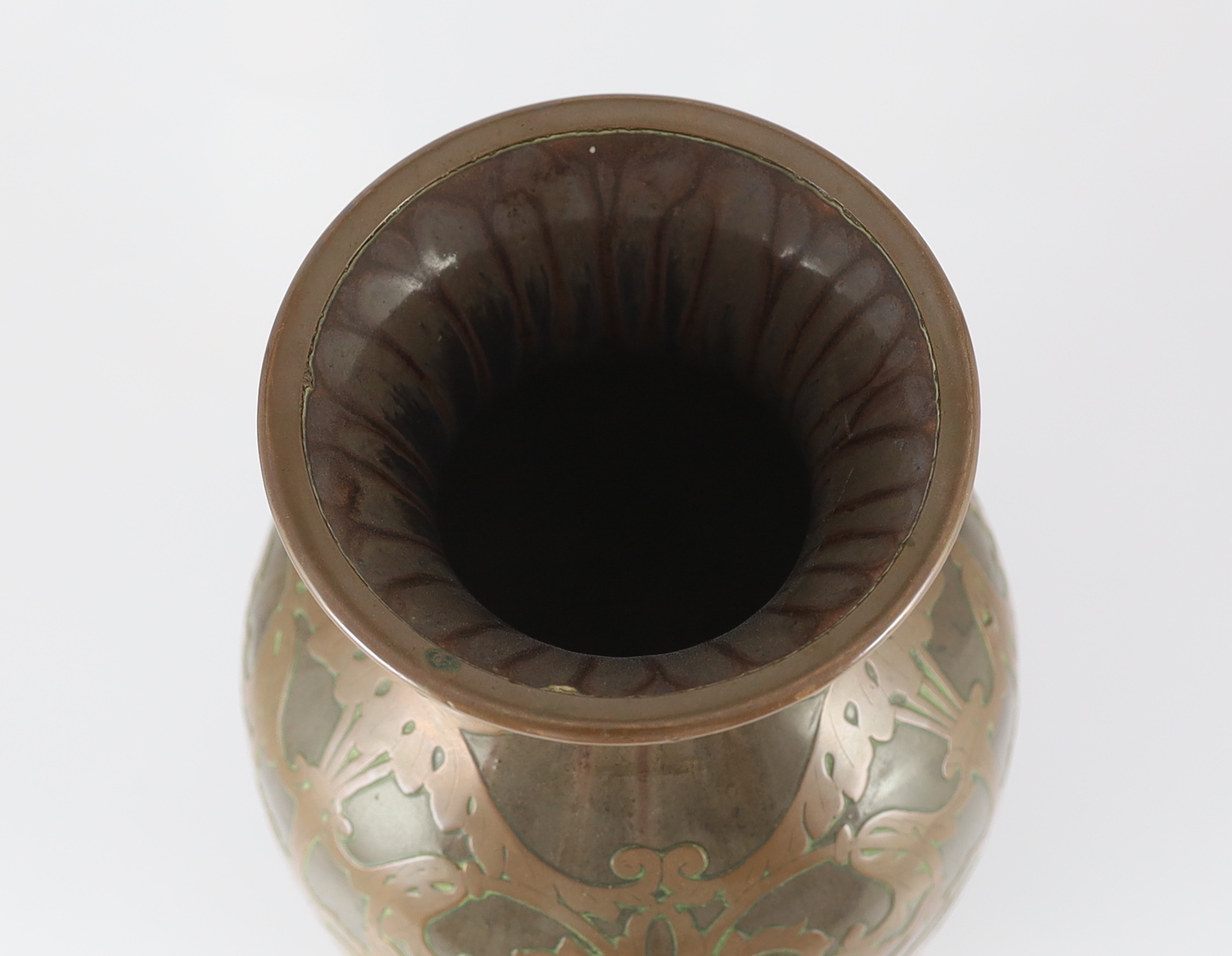Attributed to Peter Behrens (German, 1868-1940). An Art Nouveau pottery and copper overlaid vase by Marzi & Remy, Hohr